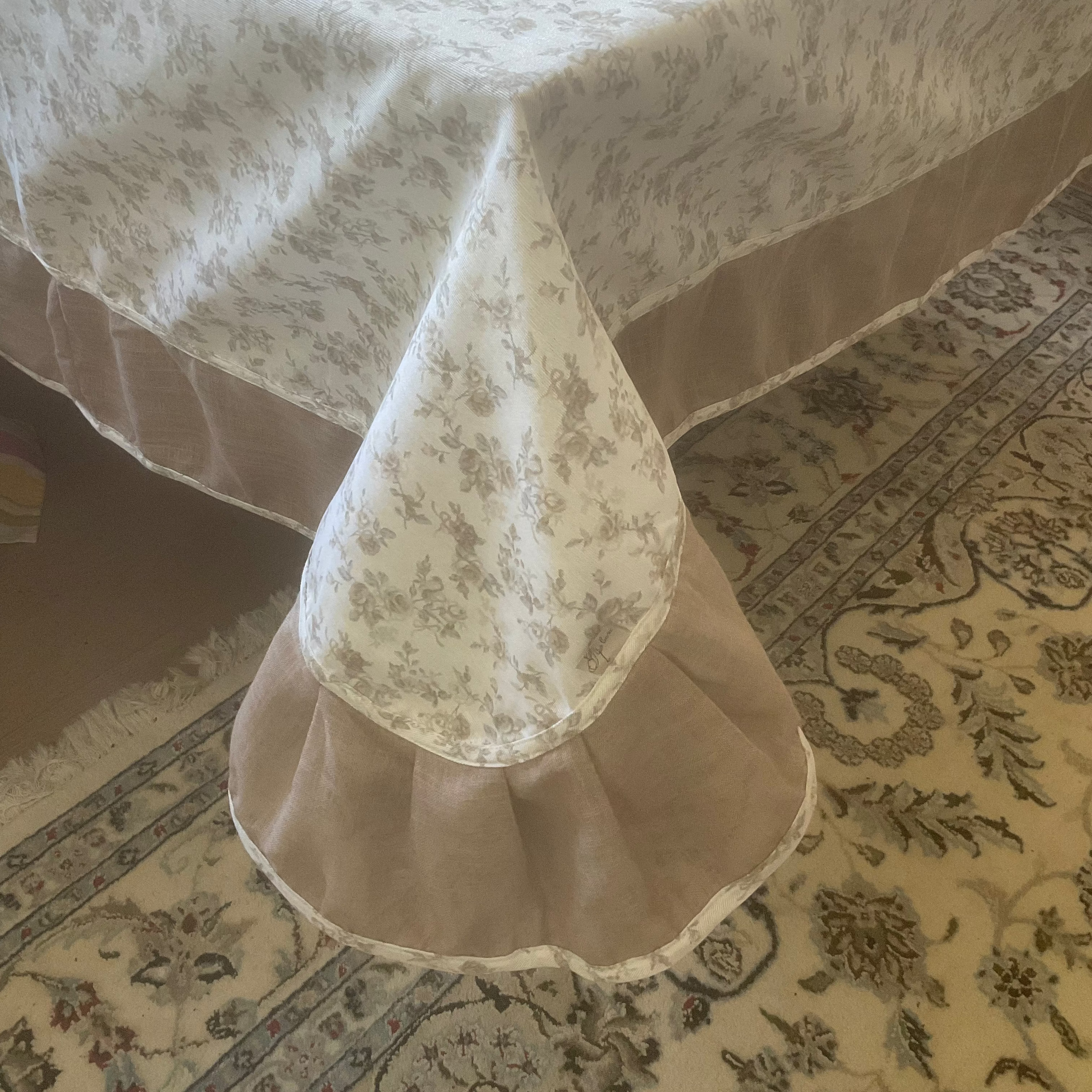 Ukrainian floral tablecloth with beige rose pattern on dining table