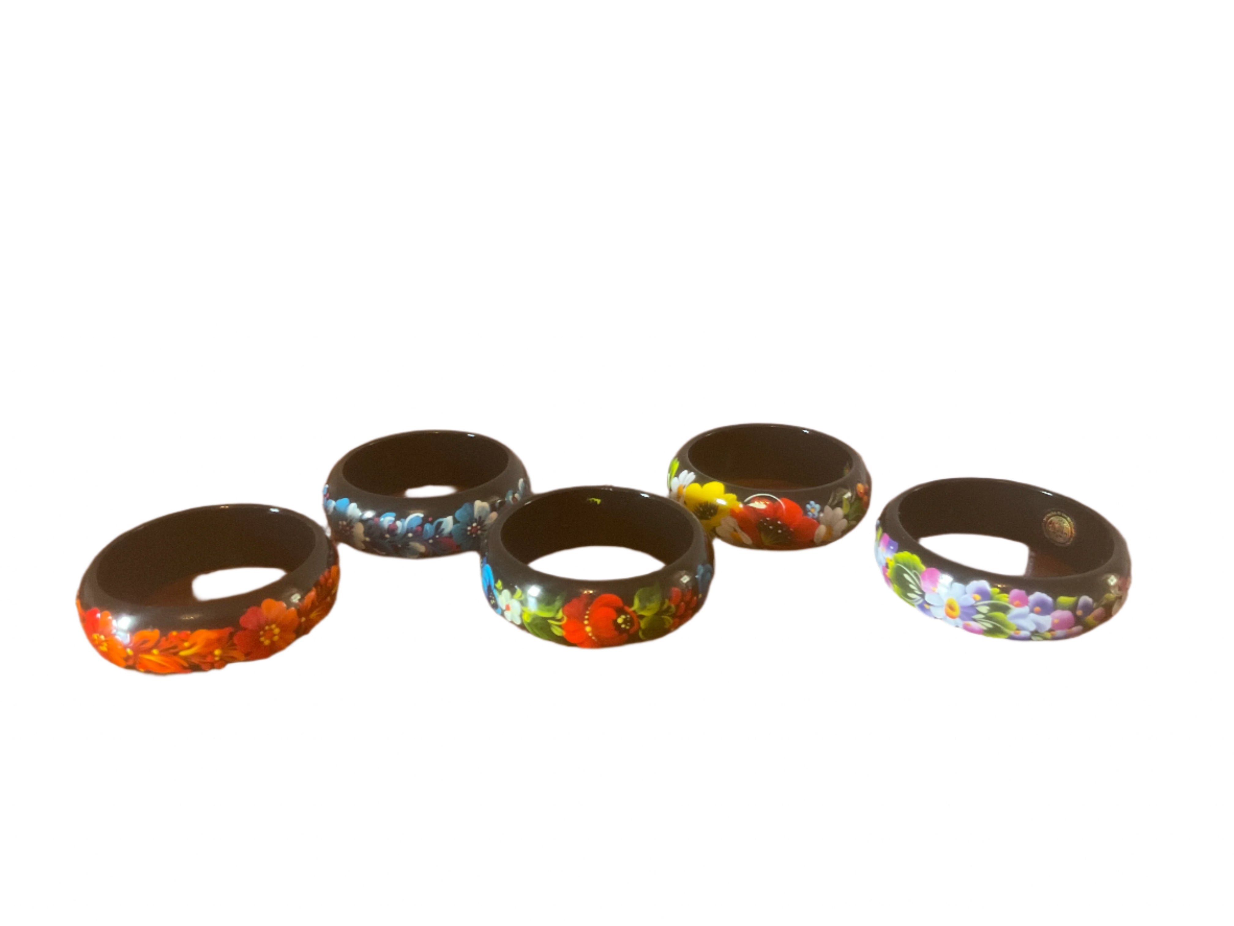 Hand-painted Ukrainian bracelets featuring traditional Petrykivka floral design