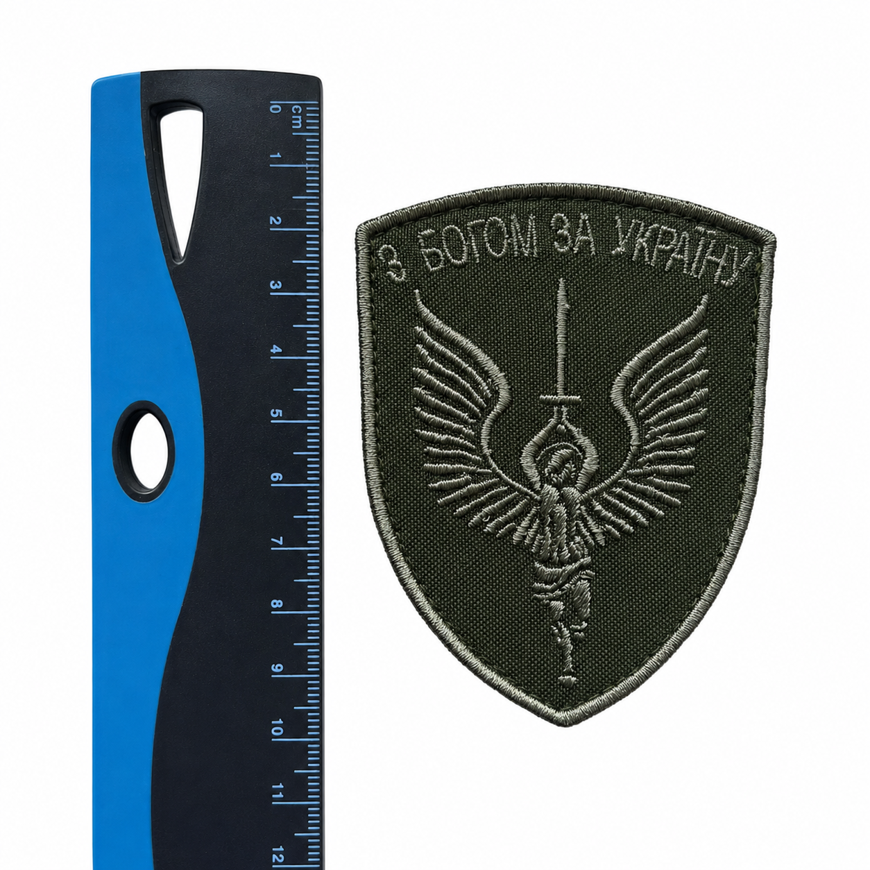 With God for Ukraine embroidered patch displayed beside a centimetre ruler