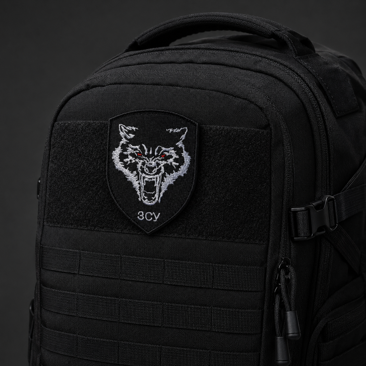 Ukrainian ЗСУ wolf embroidered patch attached to a black tactical backpack