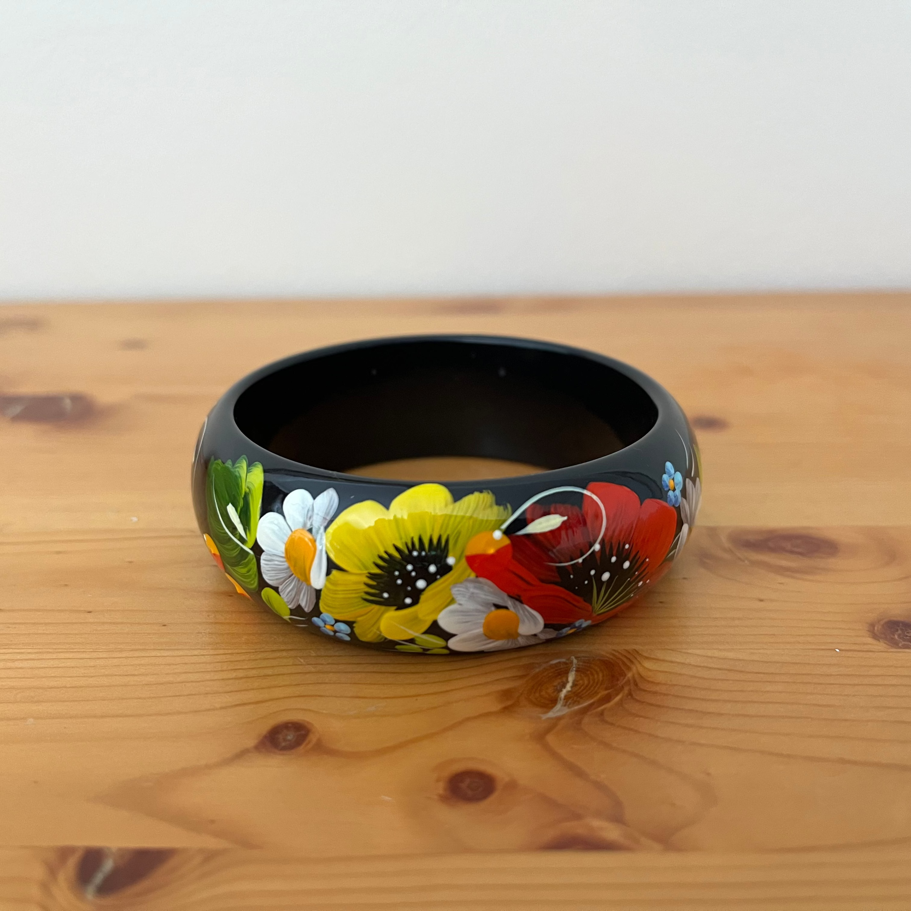 Authentic Ukrainian wooden bracelet with hand-painted daisies and poppies in Petrykivka style
