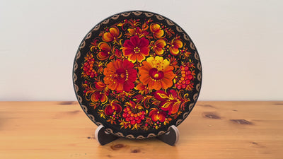 Traditional Ukrainian folk art decorative plate with hand-painted red blossoms