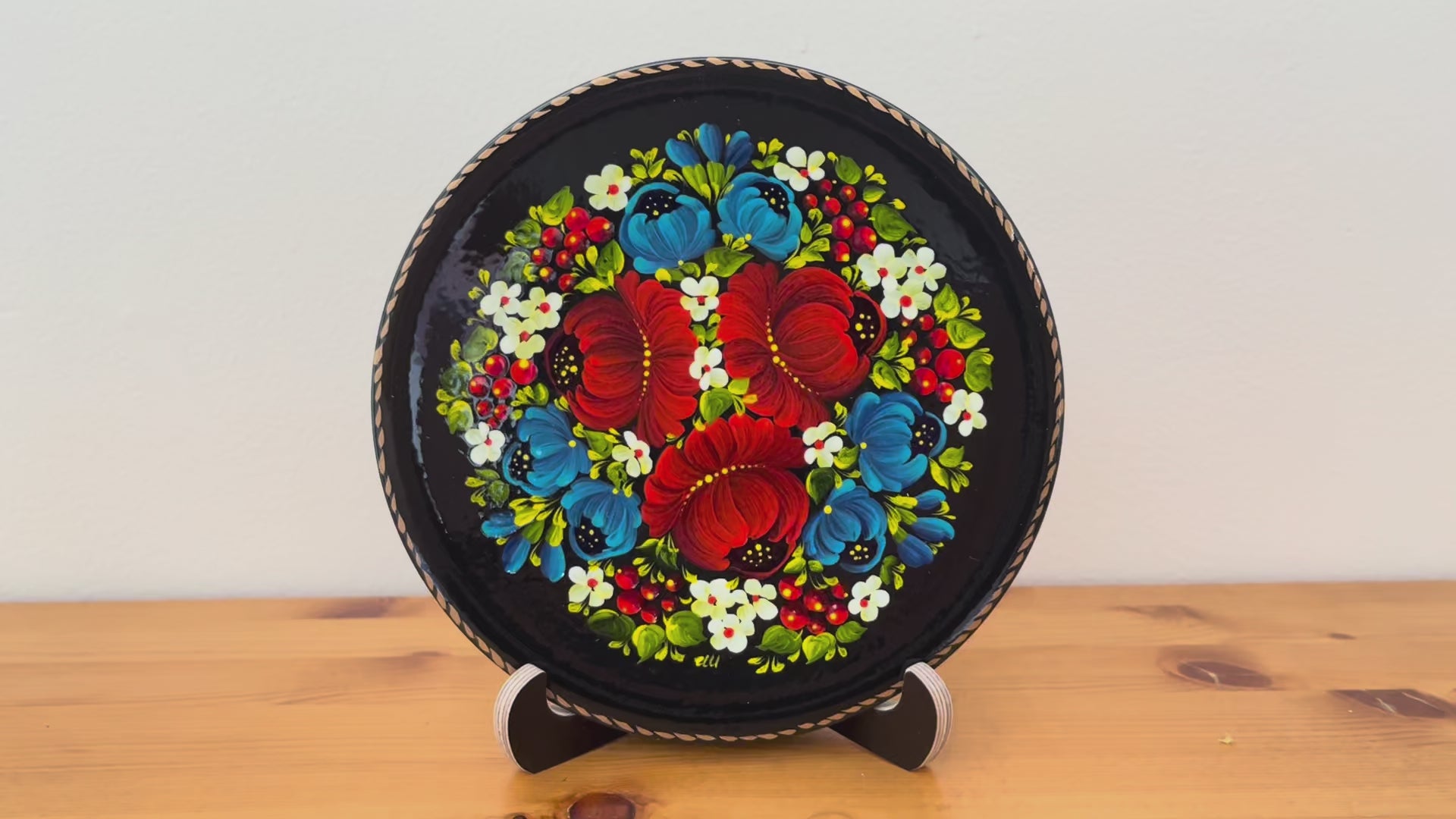 Ukrainian folk art decorative plate with symbolic red poppies