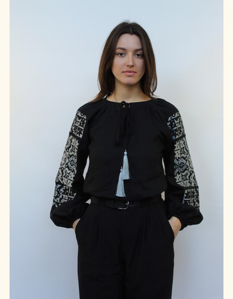 Woman wearing Star black linen vyshyvanka with silver embroidery made in Ukraine