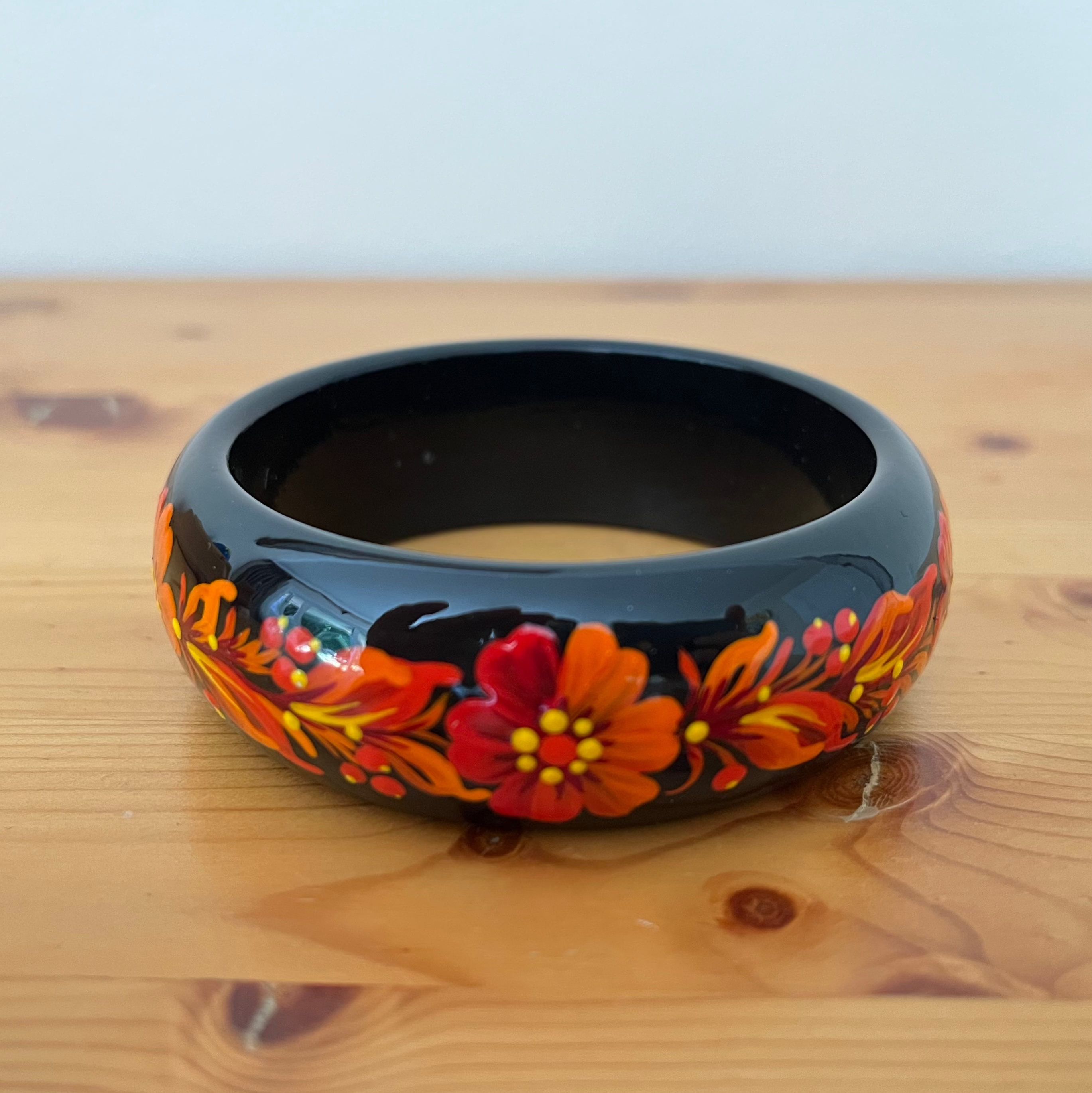 Close-up of Fire Blossom Petrykivka bracelet with vivid hand-painted floral details
