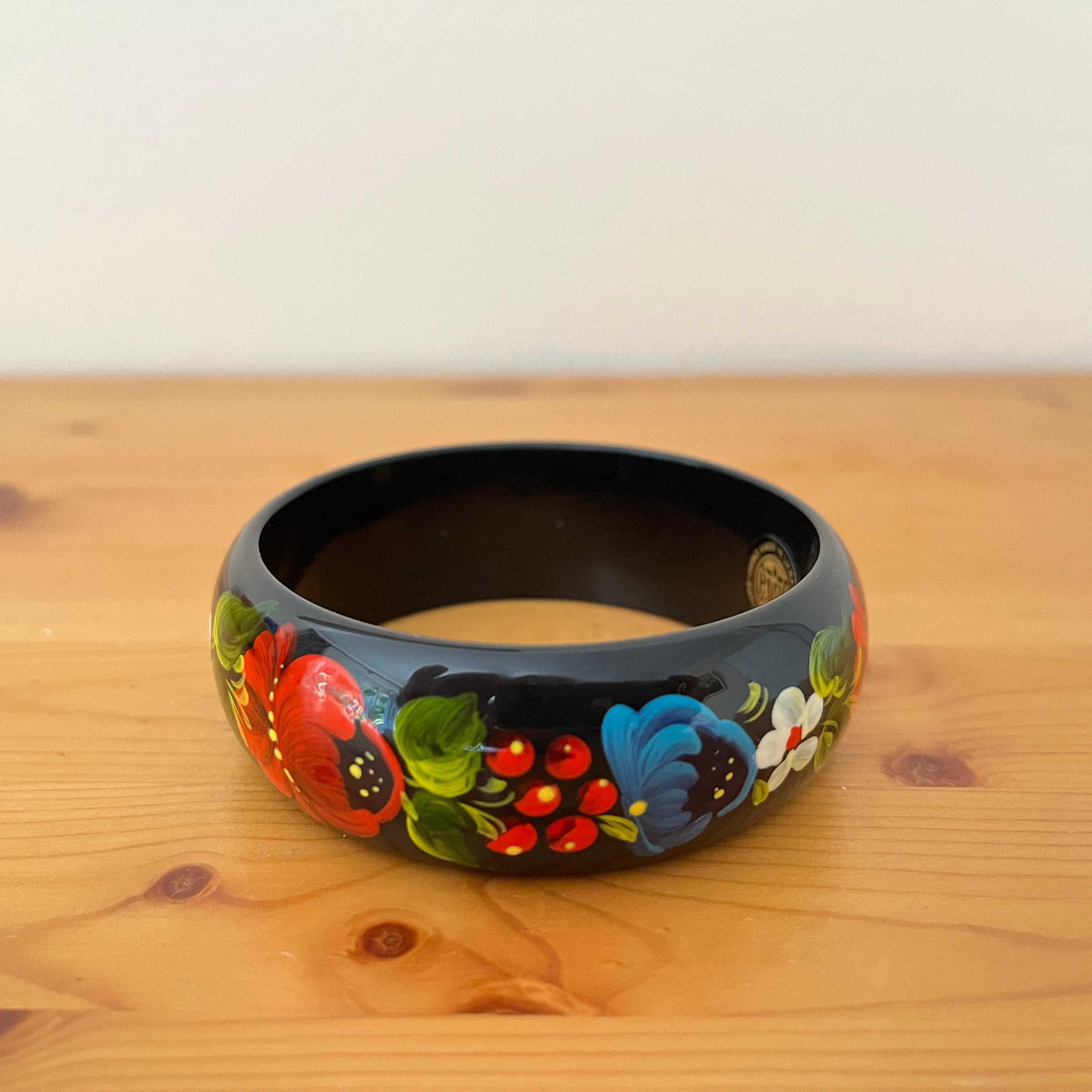 Handmade Ukrainian folk art bracelet decorated with traditional Petrykivka poppy flowers