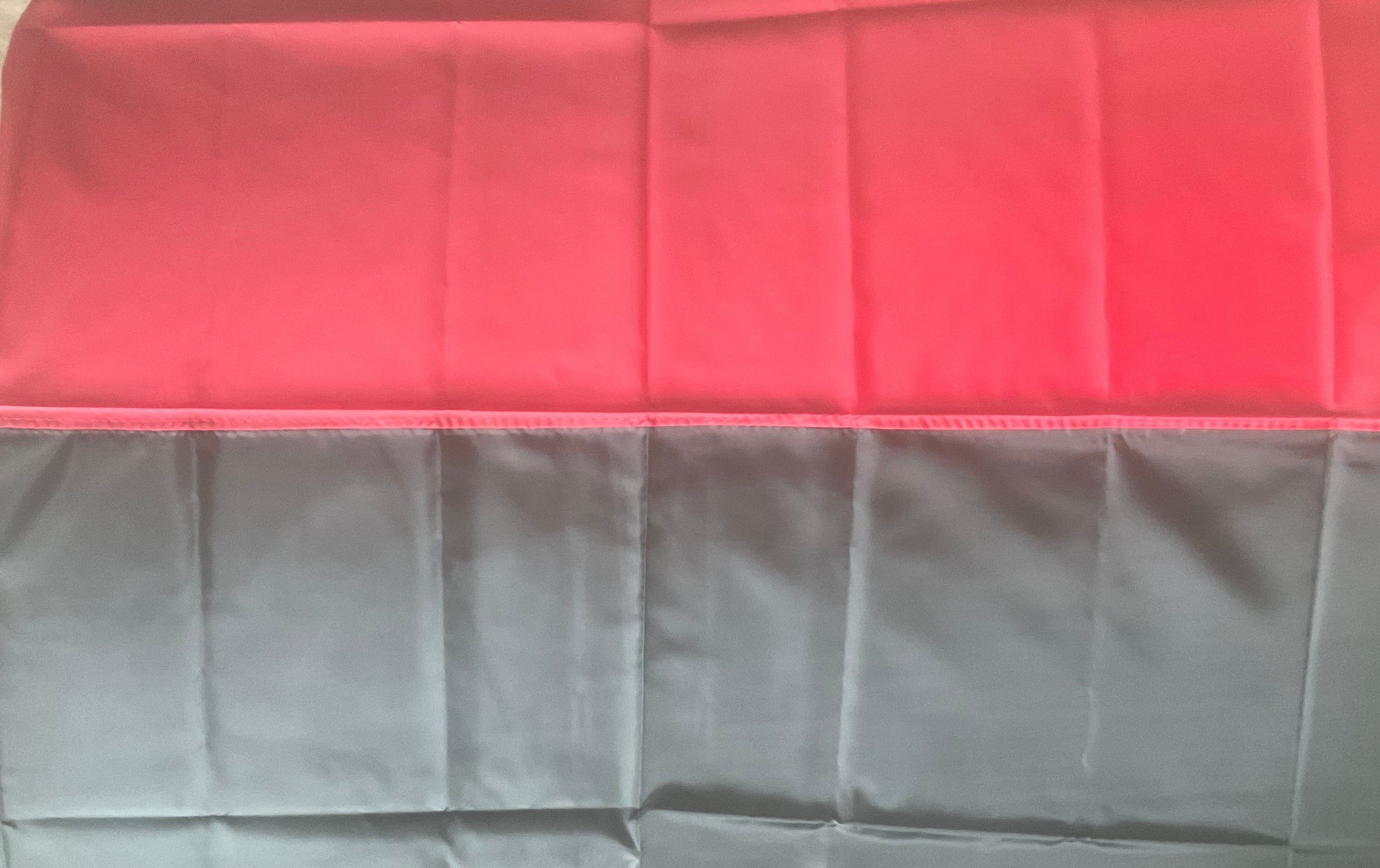 Authentic red and black Ukrainian flag with sewn pole sleeve