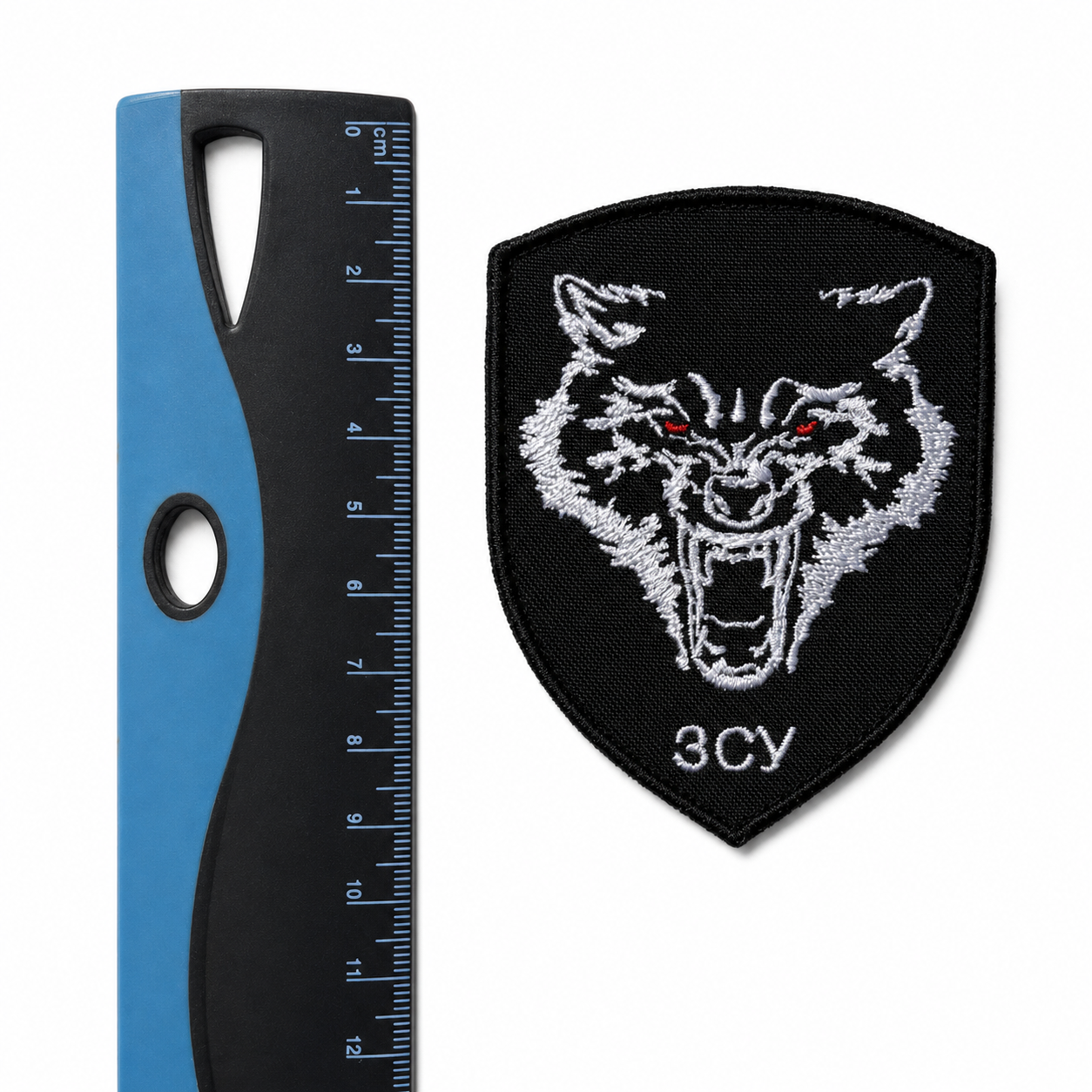 Ukrainian ЗСУ wolf patch displayed beside a centimetre ruler